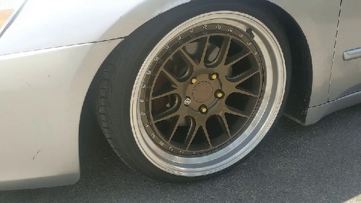 Custom alloy wheel on a parked car at A & T Auto.