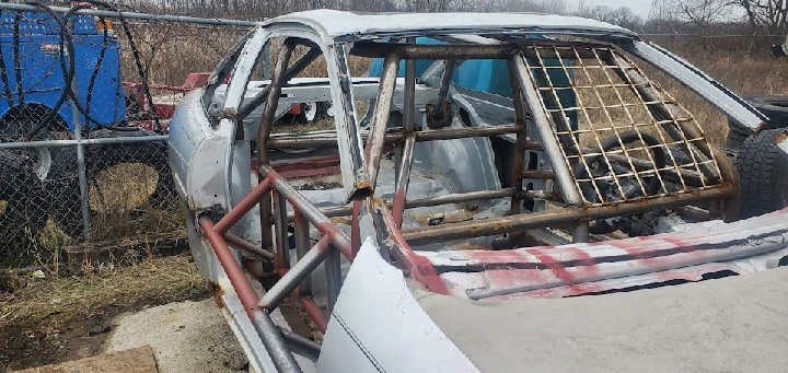 Dismantled car frame at a salvage yard.