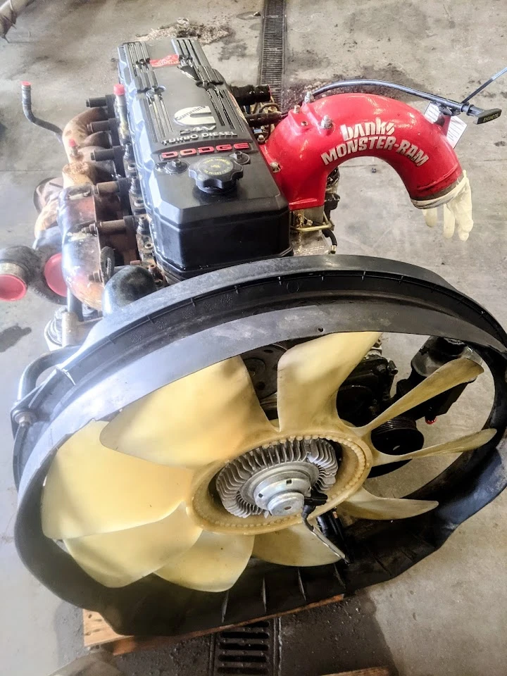 Dodge engine with fan and intake in a workshop.