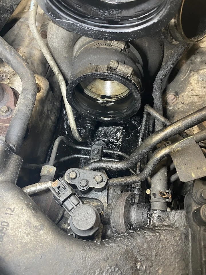 Engine components showing oil residue.