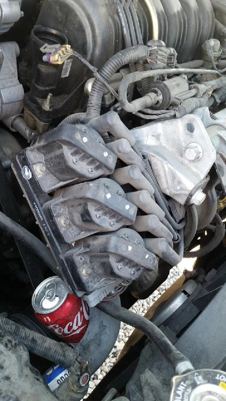 Engine components with a soda can nearby.