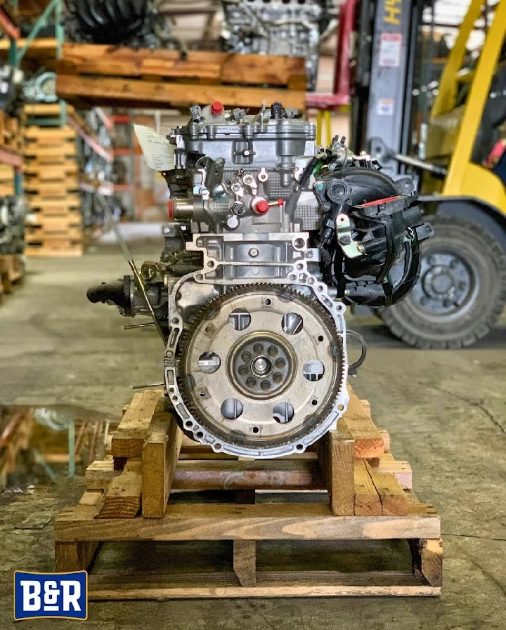 Engine displayed on a wooden pallet at B&R Auto Wrecking.