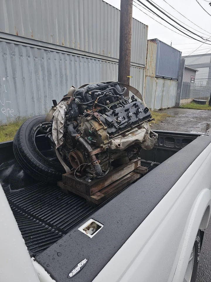 Engine on a wooden stand in a truck bed.