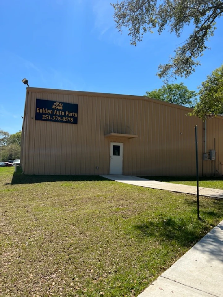 Exterior of Golden Auto Parts building with signage.