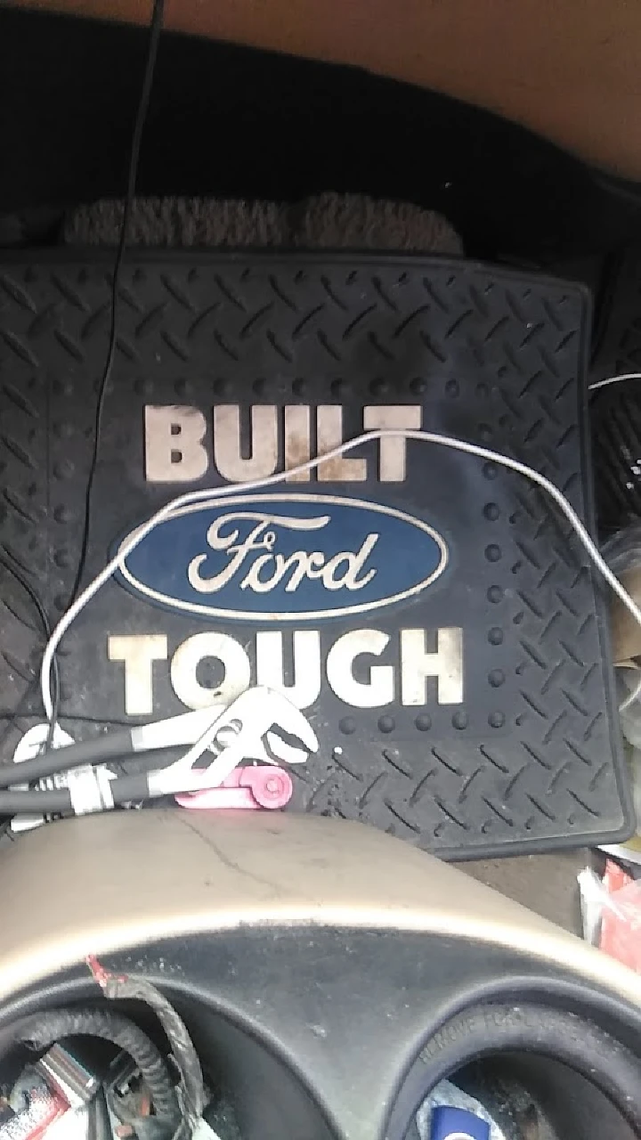 Ford mat labeled Built Ford Tough with tools nearby.