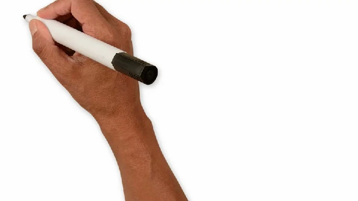 Hand holding a marker on a blank background.