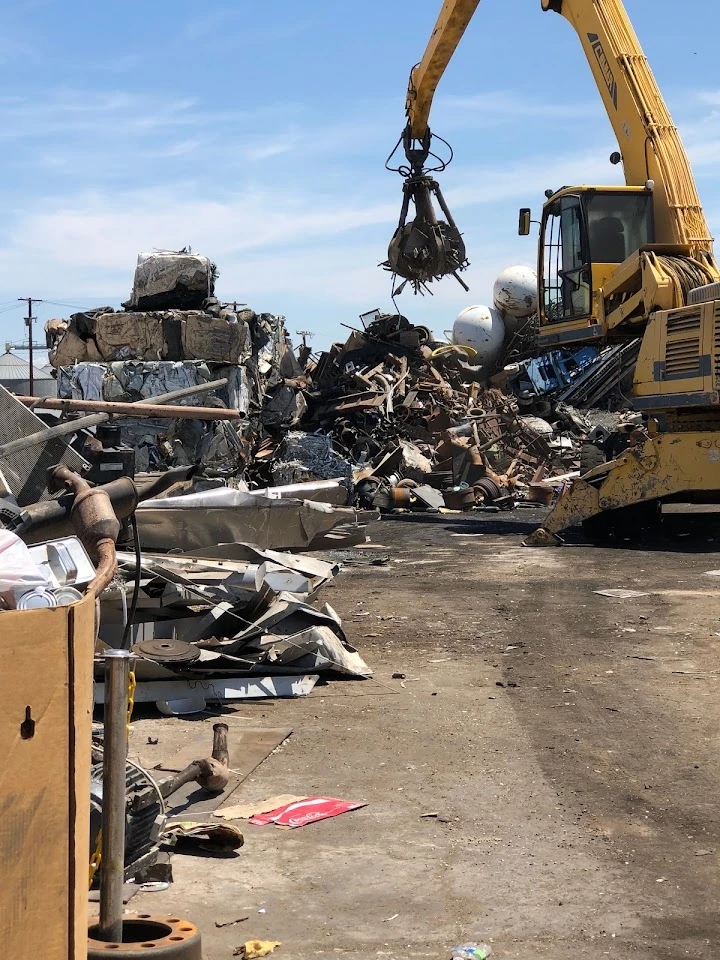 Heavy machinery at a recycling facility processing metal.