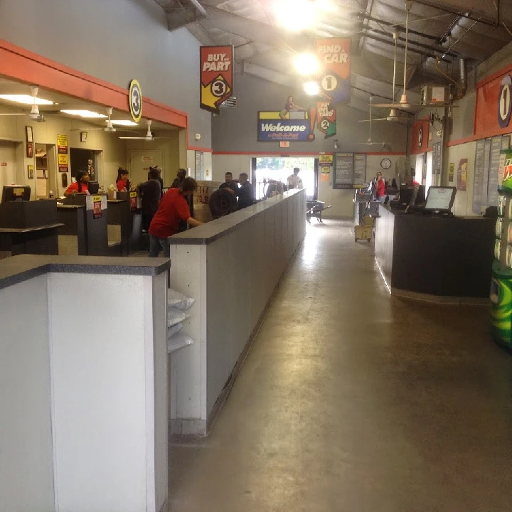 Inside a Pull-A-Part store with customers and staff.