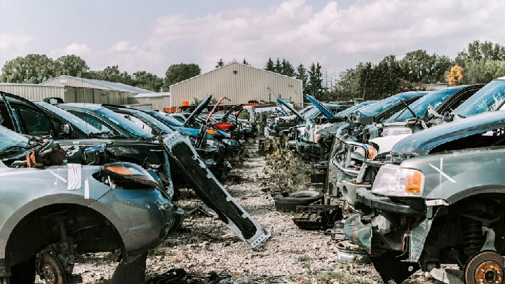 Junkyard filled with discarded cars and parts.