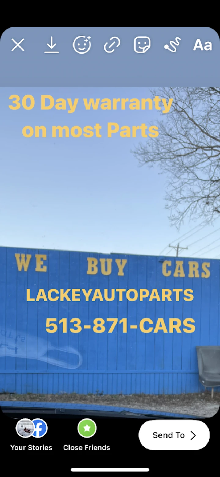 Lackey Auto Parts sign promoting warranties and services.