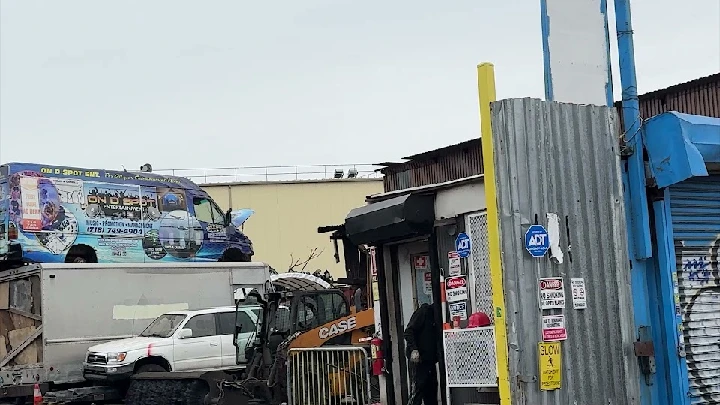 NYC Auto Recycling facility with parked vehicles.