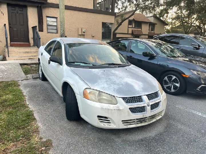 Old car parked outside a building. Buy junk cars.