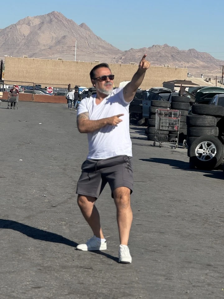 Person dancing in a parking lot at Nevada Pic A Part.