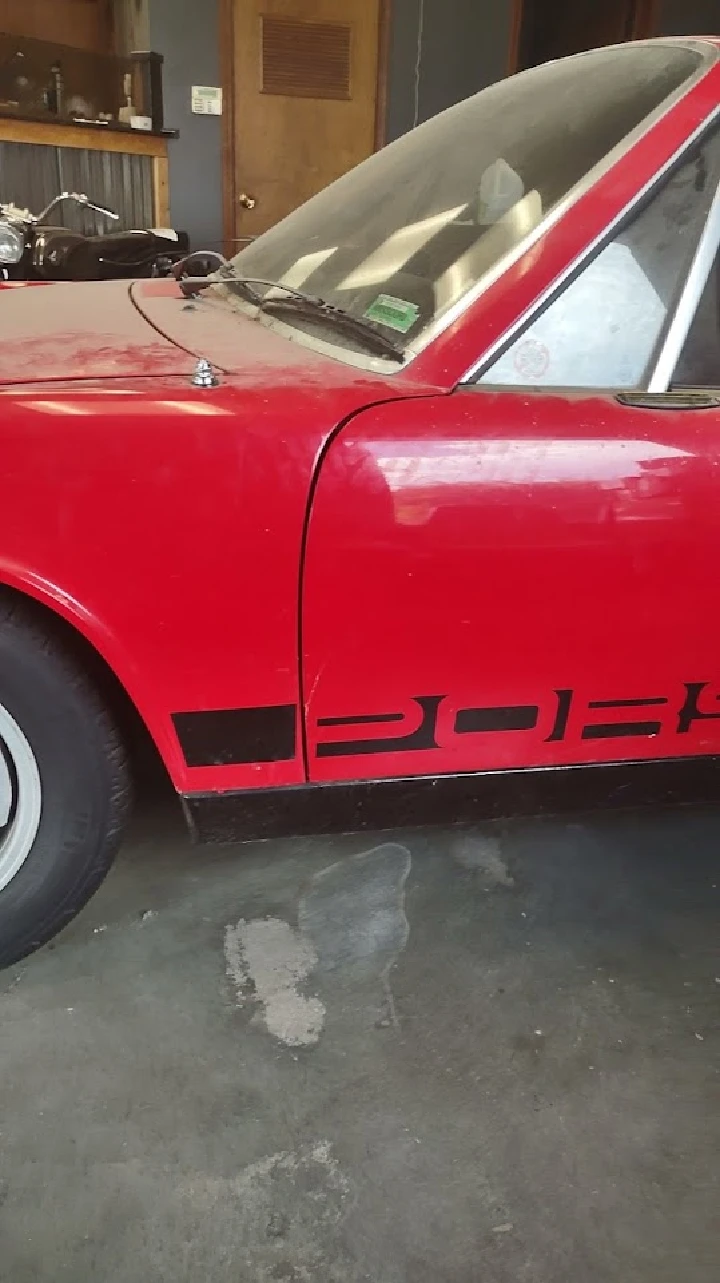 Red car side view with markings on the door.