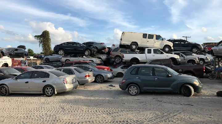 Rows of stacked cars in a junkyard.