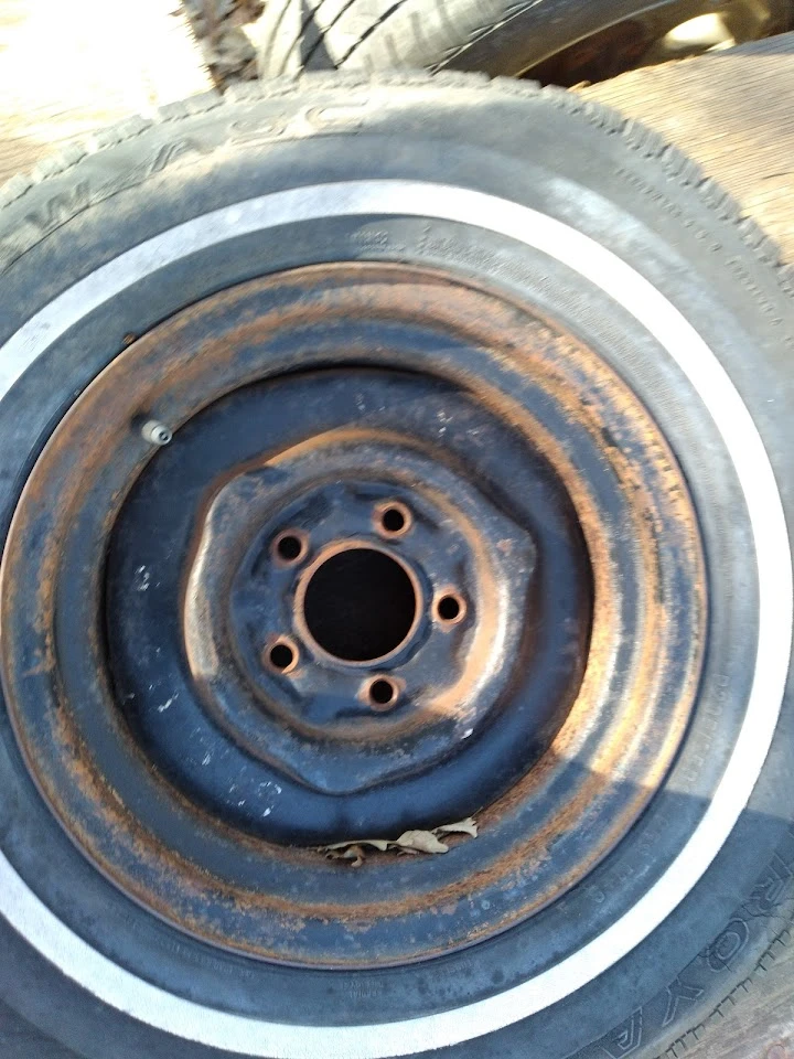 Rusty wheel rim with visible wear and tear.