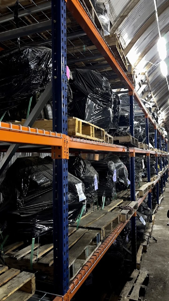 Shelves filled with used auto parts in storage.