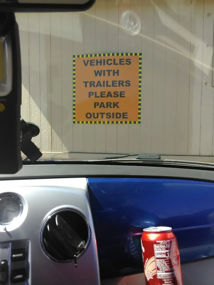 Sign directing trailer vehicles to park outside.