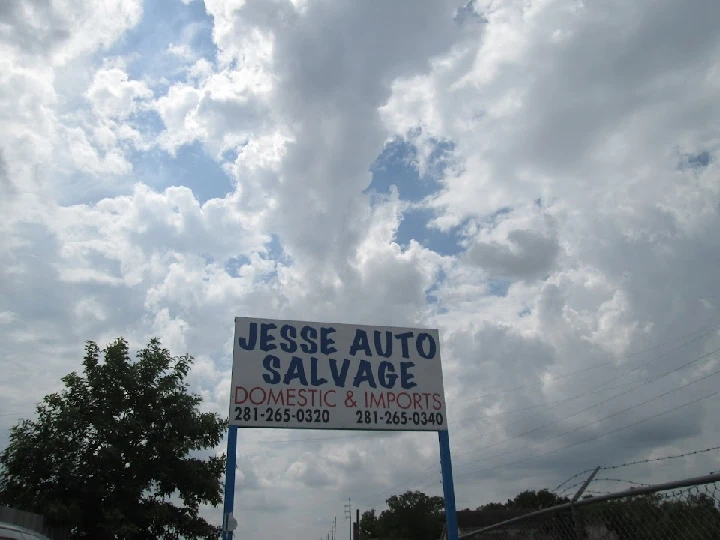 Sign for Jesse Auto Salvage with contact details.