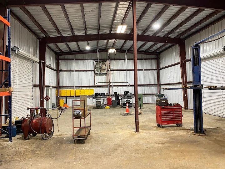 Spacious workshop interior with equipment and tools.