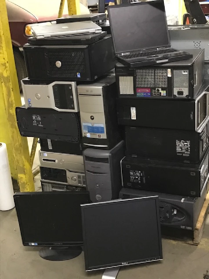 Stack of old computers and monitors for recycling.