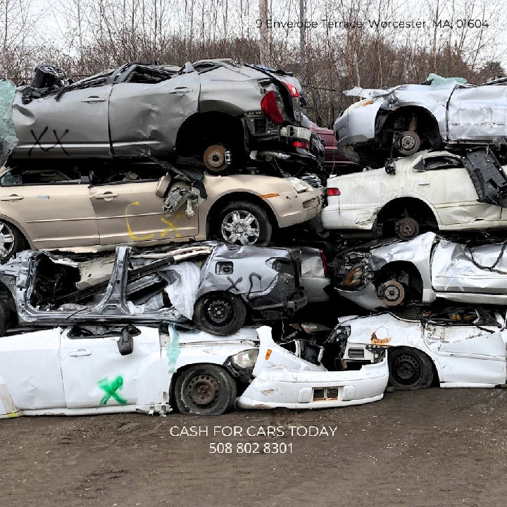 Stacked junk cars at Cash For Cars in Worcester.