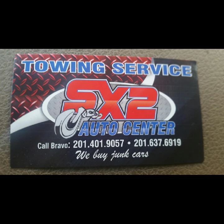 Sx2 Auto Center business card with towing service info.