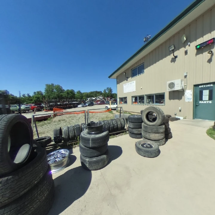 Tires stacked outside a recycling facility.