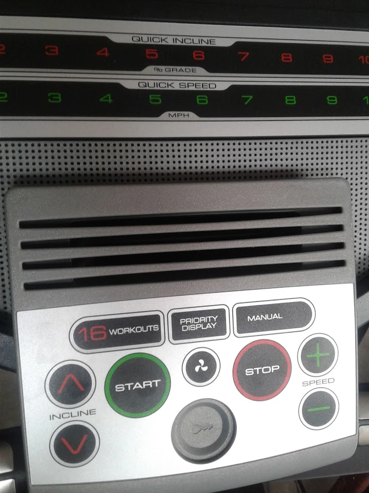 Treadmill control panel with workout settings displayed.