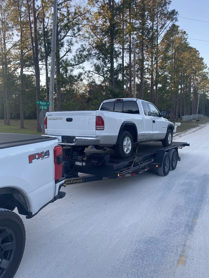 Truck being transported on a flatbed trailer.