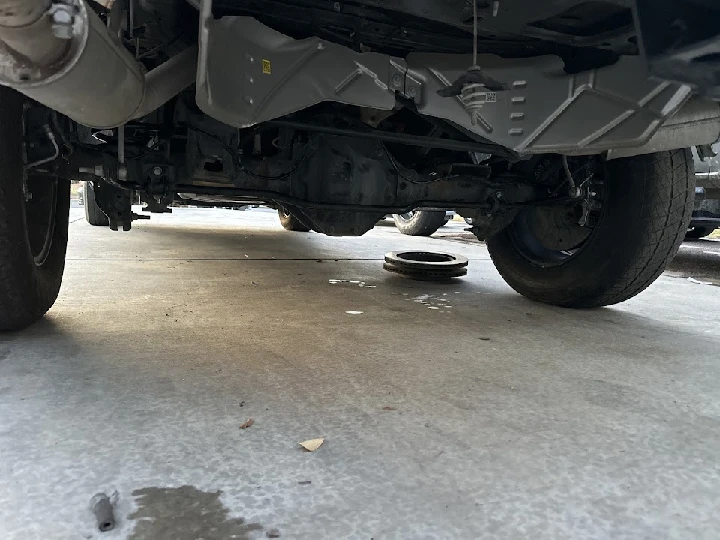 Undercarriage view of a vehicle at auto salvage.