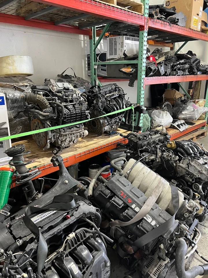 Used auto parts and engines on shelves.