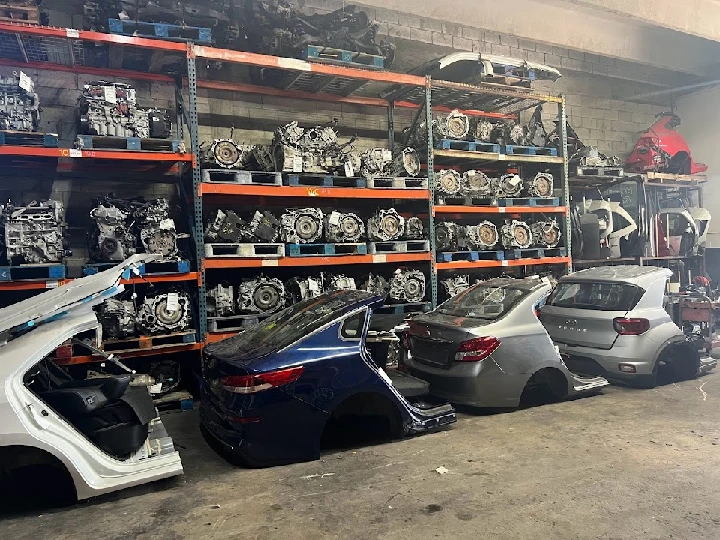 Used auto parts storage with various car components.