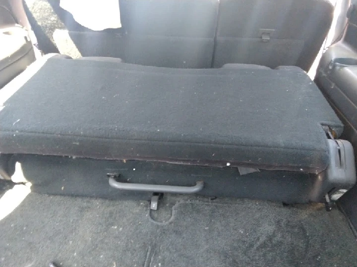 Used black car seat in a vehicle interior.