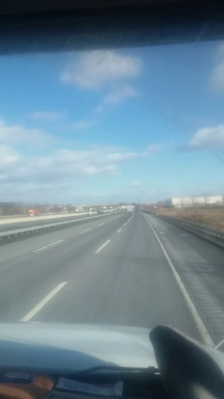 View of an empty highway under a clear sky.