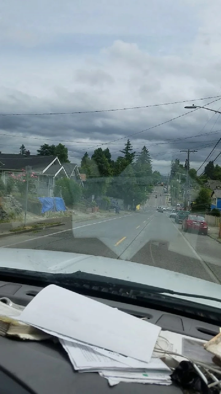 View of a street from a vehicle's dashboard.