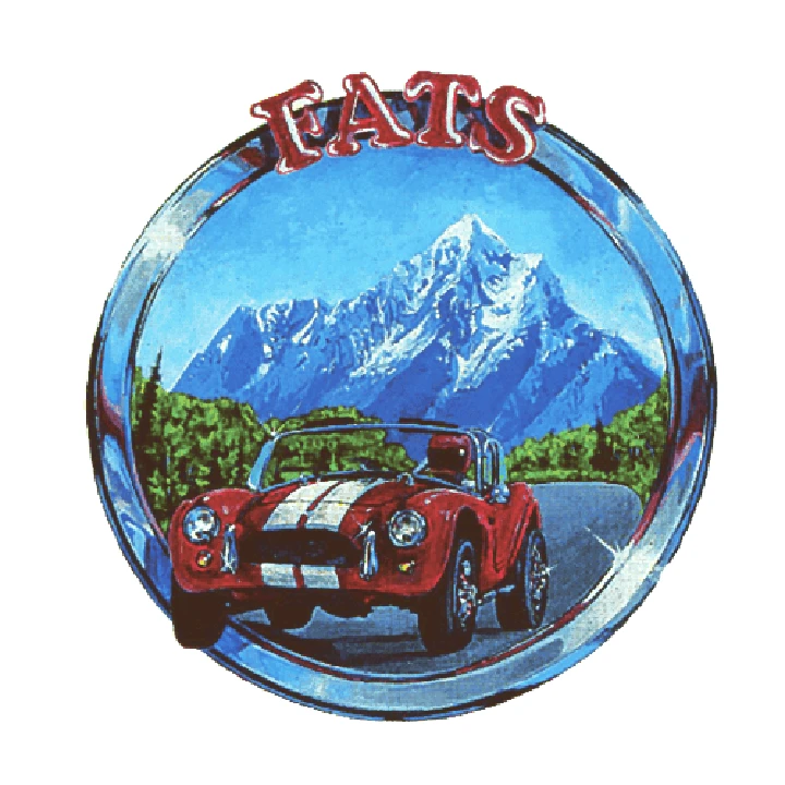 Vintage car with mountains in a circular logo.