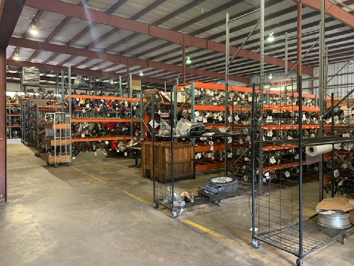 Warehouse filled with auto parts and shelves.