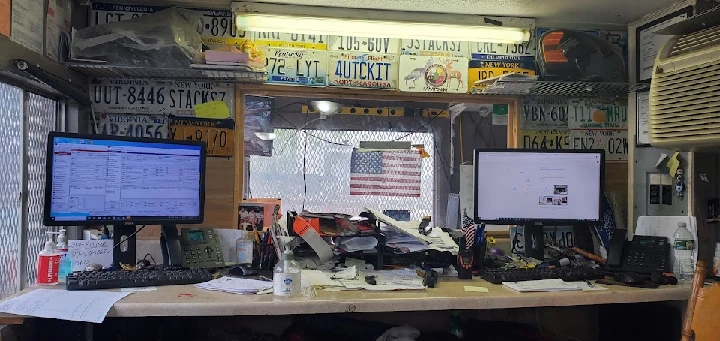 Workstation at A & T Auto Salvage Inc. with clutter.