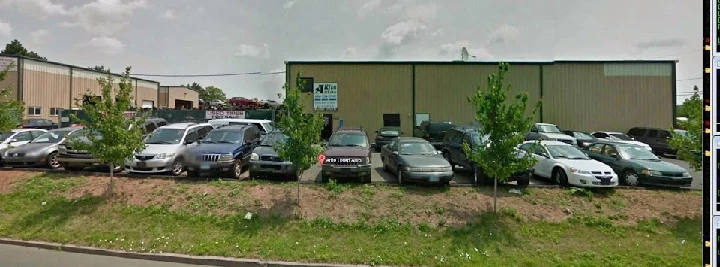 Arite Used Auto Parts lot with various vehicles.