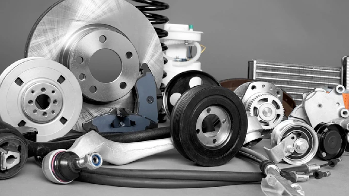 Assorted auto parts and components on a surface.