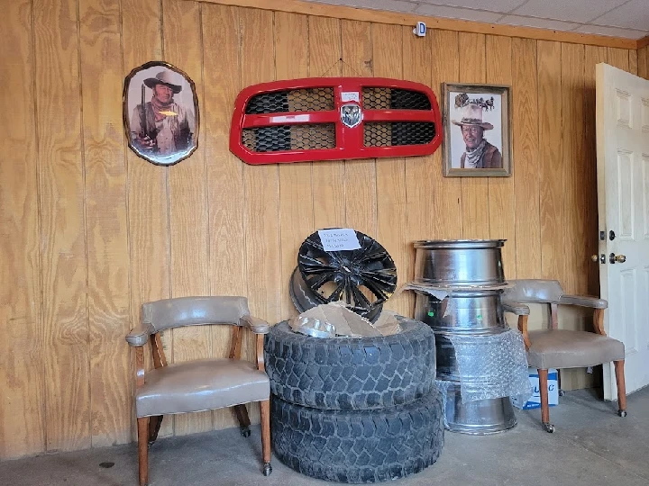 Auto parts display with tires and wheels.