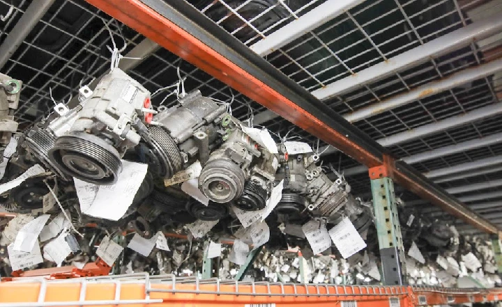 Auto parts hanging on racks for dismantling.