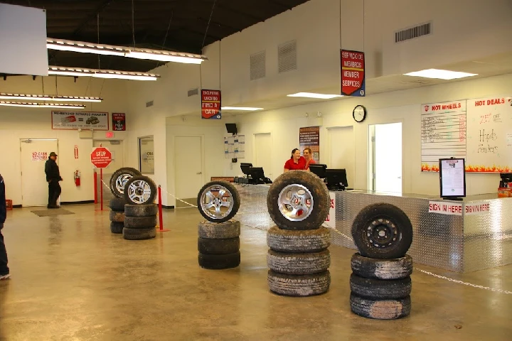 Auto parts store interior with tires on display.