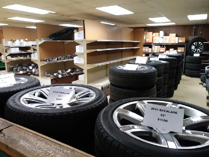 Auto parts store with tires and wheels displayed.