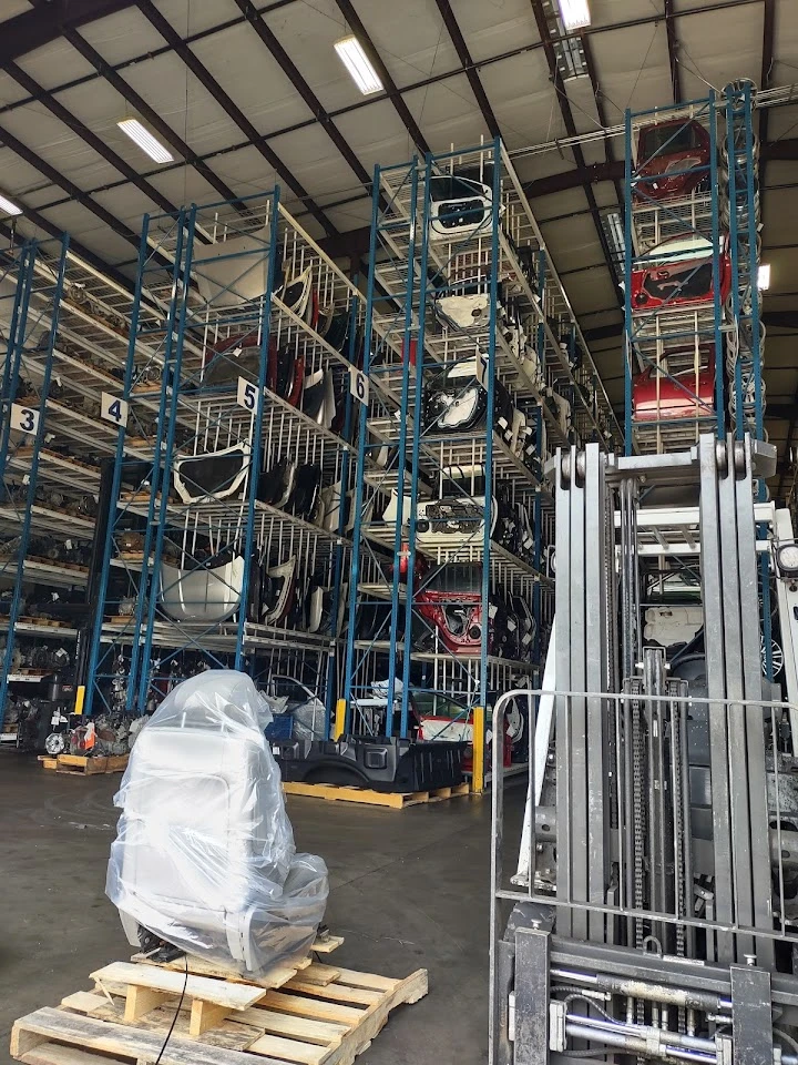 Auto parts warehouse with stacked shelves.