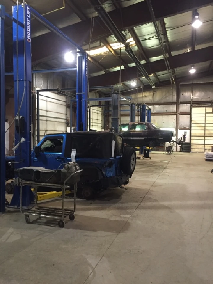 Auto repair shop with vehicles on lifts.