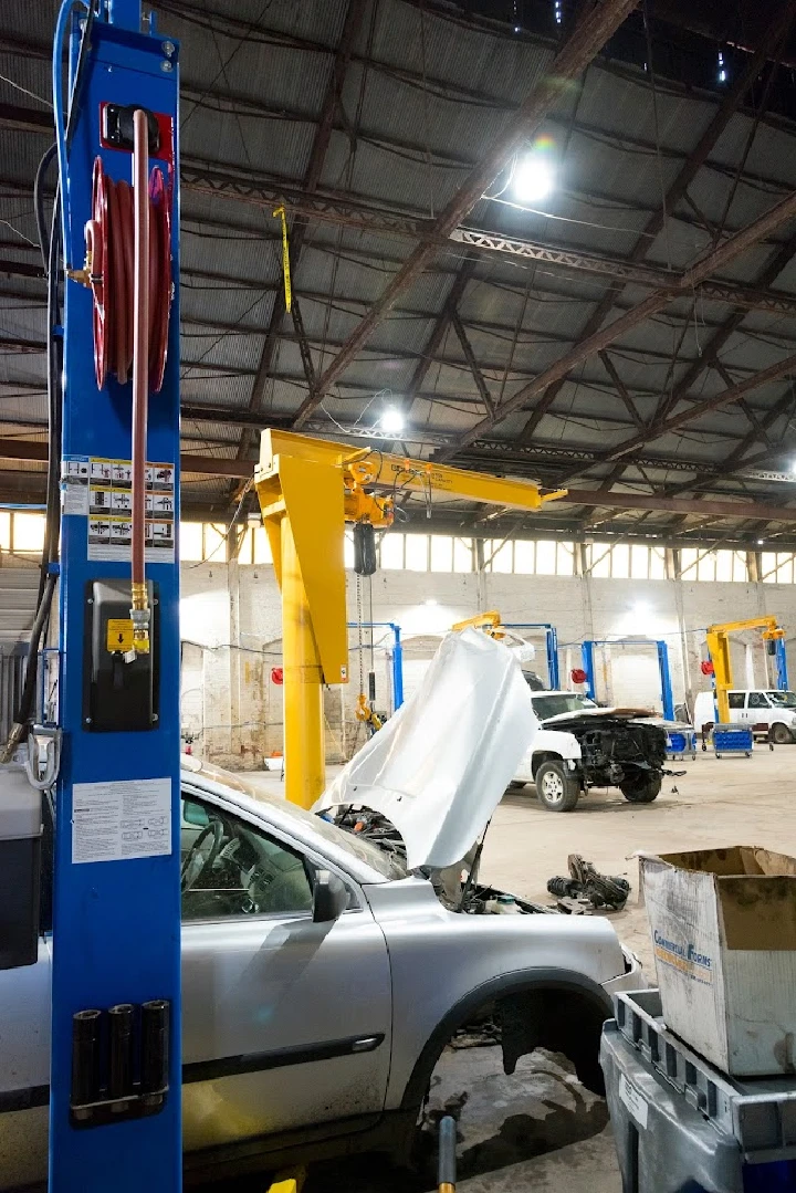 Auto repair workshop with vehicles and equipment.