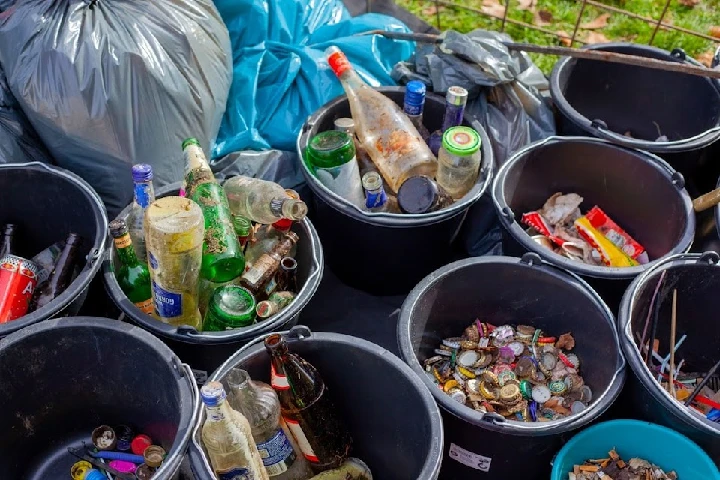 Buckets filled with various collected recycling items.