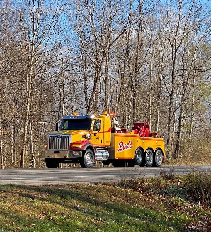 Bud's Wrecker Service tow truck on a roadway.